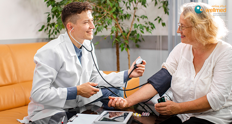 A doctor checking a senior woman's blood pressure.